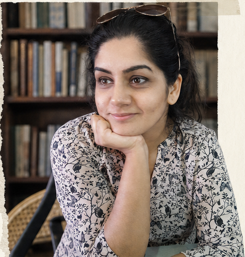 Mehreen Arshi seated in front of a bookshelf